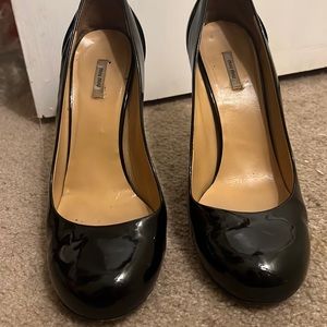 Miu Miu Round toe black patent leather pumps.
